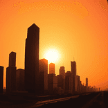 Wide angle view of tall buildings at sunset with deep shadows and vibrant sky.