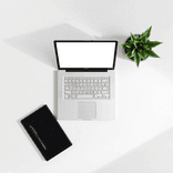 Top-down view of an open laptop on a tidy, light-colored desk.