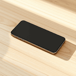 Sleek smartphone on an uncluttered oak surface with diffused illumination.